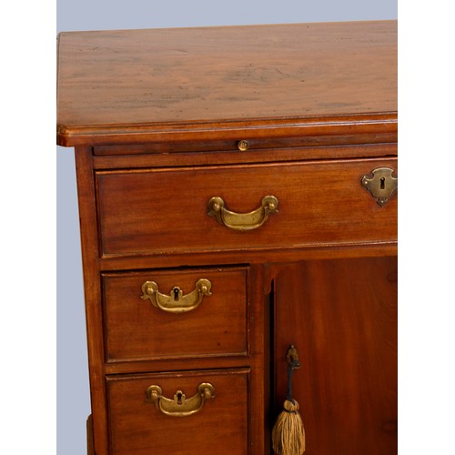 323 - A George III mahogany kneehole desk, with shaped top, pull out writing slide, over a single frieze d... 