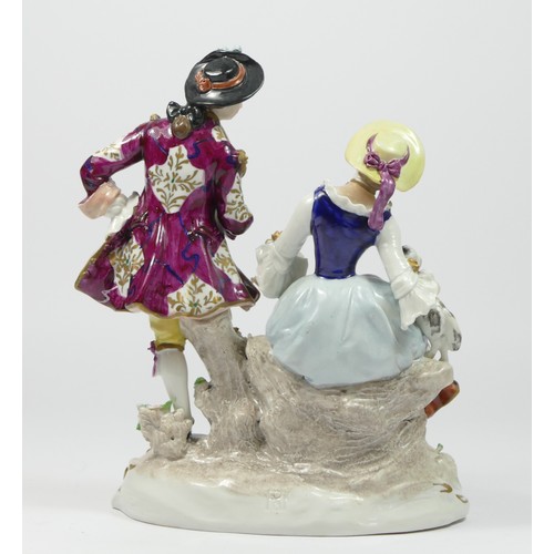 179 - Sitzendorf, a seated man and woman hard paste porcelain figure group, with a dog and a sheep.