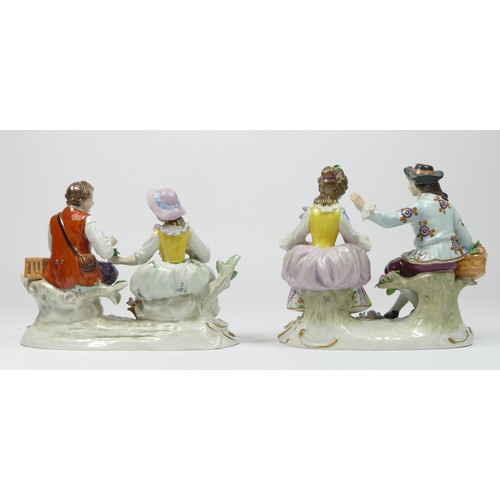 180 - Sitzendorf, a seated man and woman hard paste porcelain figure group, with a basket of flowers, and ... 