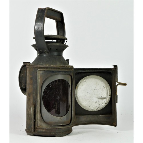 92 - An unmarked three aspect hand lamp, complete with burner, 31cm tall