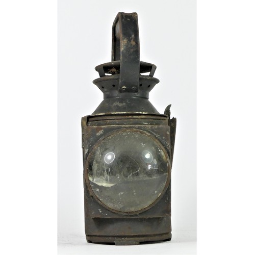 92 - An unmarked three aspect hand lamp, complete with burner, 31cm tall