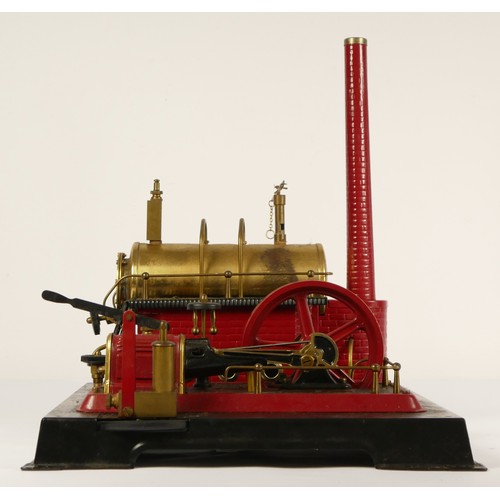 187 - A Marklin style horizonal boiler live steam stationary engine, of tin plate construction, red and bl... 