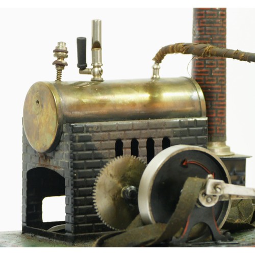 199 - A Doll et Cie vintage tinplate live steam horizontal engine, 24 x 21cm.
Doll et Cie (DC), were found... 