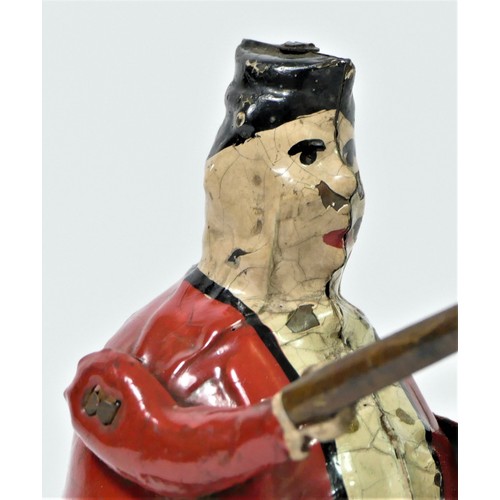 210 - A tinplate toy, depicting a gentleman riding a tricycle, hand painted figure, 14cm tall