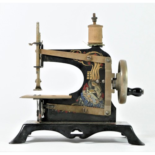 211 - A child's tinplate toy sewing machine, painted, depicting Snow White And The Seven Dwarfs, stamped f... 