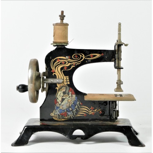 211 - A child's tinplate toy sewing machine, painted, depicting Snow White And The Seven Dwarfs, stamped f... 