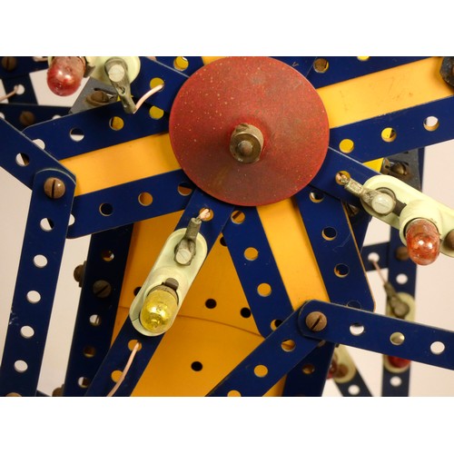 214 - A Meccano shop display, twin star, illuminated and spinning stars, yellow and blue, powered, on a wo... 