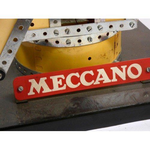 216 - A Meccano shop display, windmill, illuminated and spinning blades, yellow and silver, powered, on a ... 