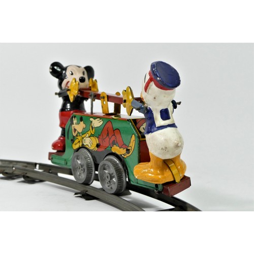 224 - A Mickey Mouse Handcar clockwork / wind up tinplate toy, with Mickey Mouse and Donald Duck operating... 