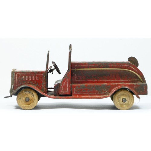 228 - A vintage red painted metal fire engine, probably American, white rubber tyres, lacking ladder, 30cm... 