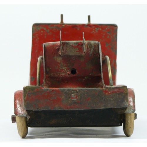 228 - A vintage red painted metal fire engine, probably American, white rubber tyres, lacking ladder, 30cm... 