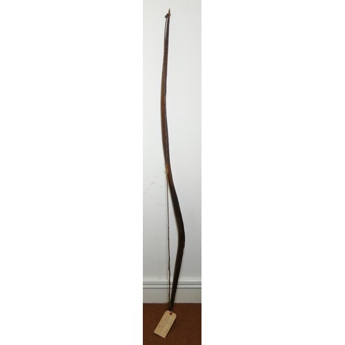 411 - A Canadian bow with cross hatched carved decoration, 148cm, with owners label 