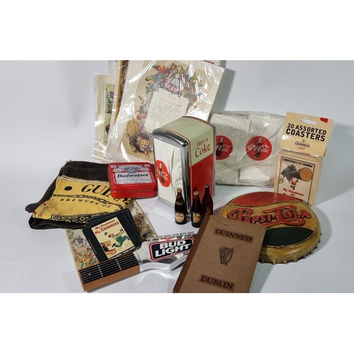 358 - A collection of Guinness memorabilia, including miniature bottles, tea towels, advertising prints, b... 