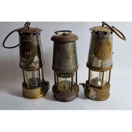 334 - Two Eccles Safety Lamps, one a 6RS, stamped 76, another a SL stamped 160, together with a Wolf Miner... 