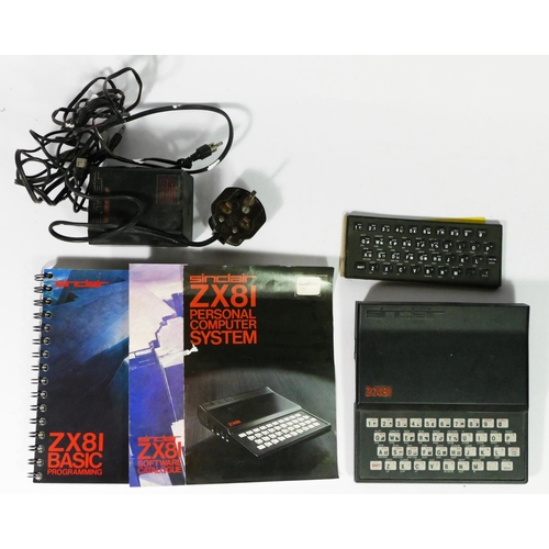 448 - A Sinclair ZX81, AV and power cables, keyboard, manual, Basic programming book and software catalogu... 