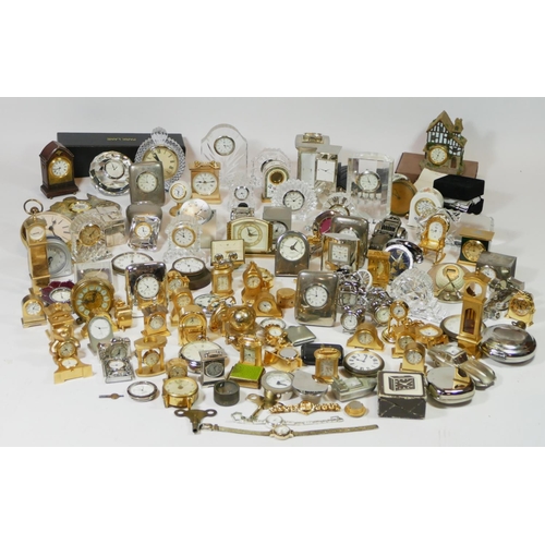 71 - A large collection of miniature novelty clocks, together with a selection of traveling alarm clocks.... 