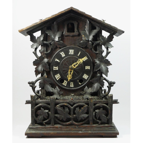 86 - A late 19th/early 20th century Black Forest bracket cuckoo clock, the circular dial bearing roman nu... 