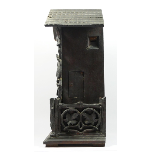 86 - A late 19th/early 20th century Black Forest bracket cuckoo clock, the circular dial bearing roman nu... 