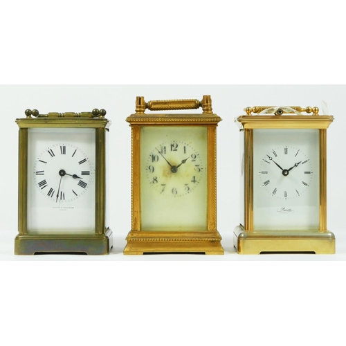 90 - An early 20th century gilt brass 8 day carriage clock, together with two French examples. (3)