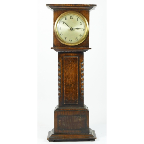 95 - A miniature oak cased longcase clock, silvered dial, brass chapter ring with manual wind movement.
4... 