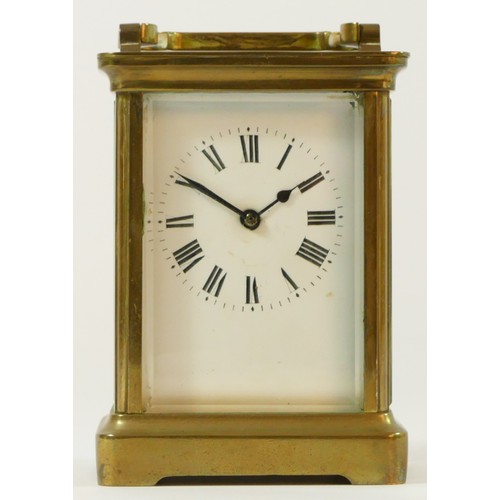 98 - A brass cased 8 day carriage clock, enameled dial with Roman numerals - 12cm tall.