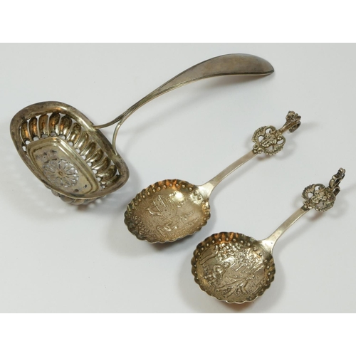 112 - A 19th century Dutch silver sifter spoon, date letter 1841, and two later Dutch silver christening s... 