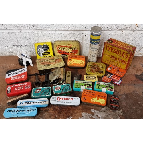 74 - A collection of cycle puncture repair tins, some with contents.