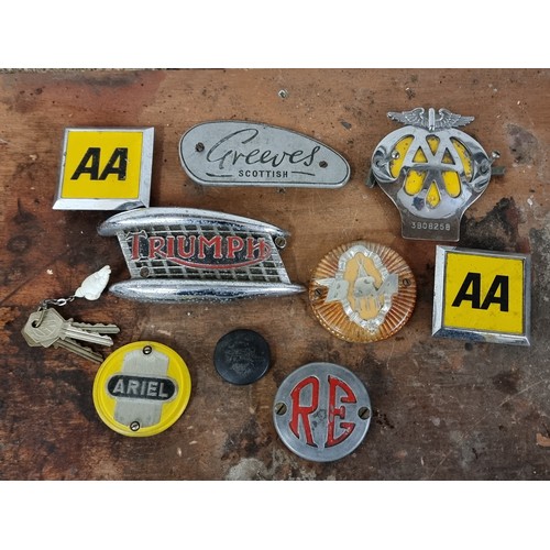 77 - A collection of motorcycle tank badges and AA badges and keys.
