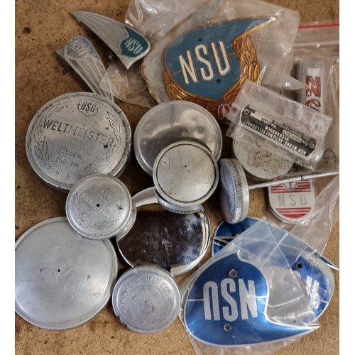 147 - A collection of NSU tank badges and filler caps.