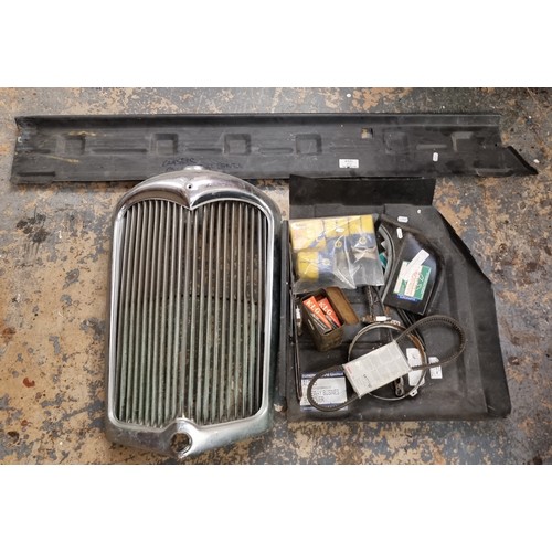 207 - A chrome radiator grill. a Mini sill and footwell panel and other spares.