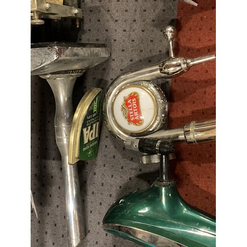 Four brewery hand pull bar pumps, to include Stella Artois, I.P.A, Carlsberg and Carling.