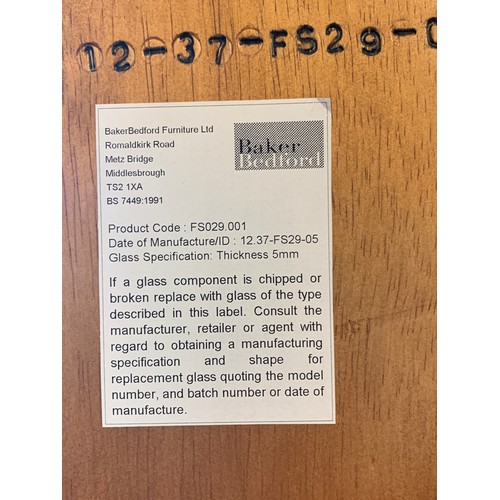 A Baker Bedford display full length lockable hinged door