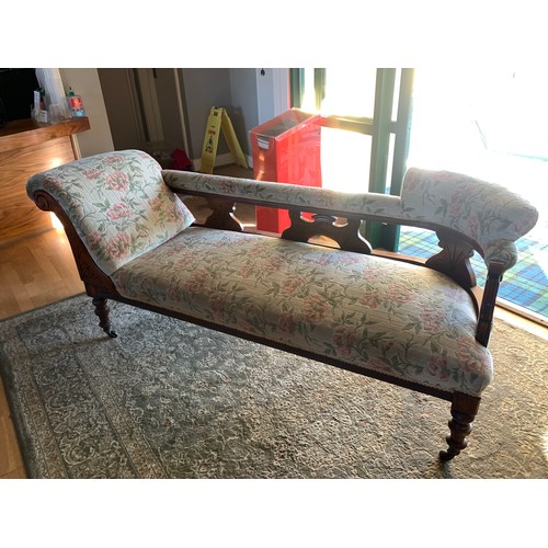 380 - A late Victorian mahogany framed scroll end chaise longue with floral chenille upholstery, raised on... 