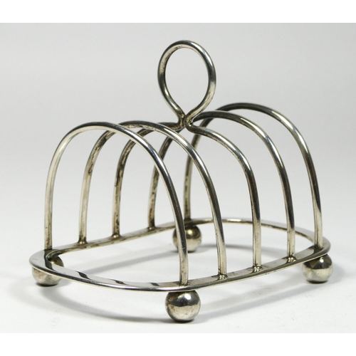 9 - An Edwardian silver four division toast rack, London 1906, raised on four ball feet, 10cm, 74gm