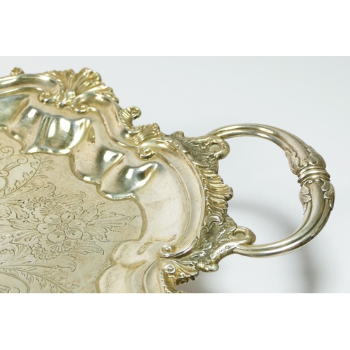 25 - An Edwardian silver two handled tray, by BB, Birmingham 1901, with floral engraved field, cast scrol... 