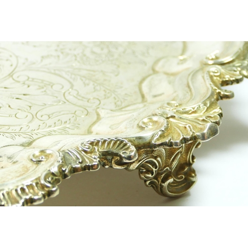 25 - An Edwardian silver two handled tray, by BB, Birmingham 1901, with floral engraved field, cast scrol... 