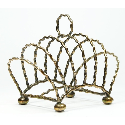 31 - A Victorian silver six division arched toast rack, by Heath & Middleton, Birmingham 1890, raised on ... 