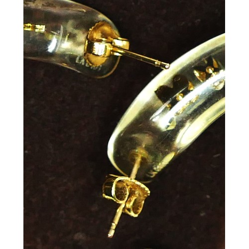 45 - Louis Vuitton, a pair of resin and encased metal ear rings, c.2000's, engraved LK 0131, diameter 50m... 