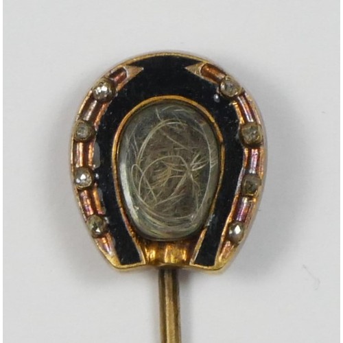 48 - A Victorian gold and enamel mourning horseshoe stickpin, the locket with coarse hair (horse?), rose ... 