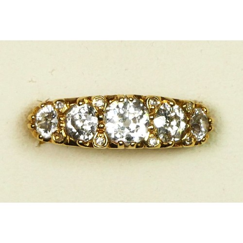 79 - An 18ct gold five stone diamond ring, carved claw set with graduated old cut stones, diamond points ... 