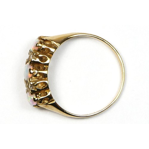 80 - An Edwardian style 9ct gold three stone opal ring, diamond points between, K, 2.1gm.