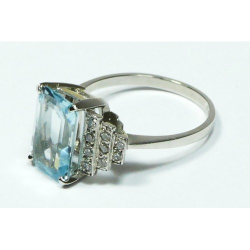 91 - An aquamarine and diamond dress ring, stamped PLAT, claw set with a step cut stone, 12 x 8mm, millig... 