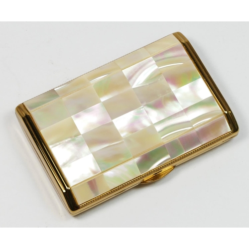 134 - Melissa, a gilt metal and mother of pearl musical ladies compact, 7.5 x 5 x 1.5cm, instructions, pou... 