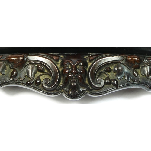 135 - A 19th century French carved lignum vitae pen tray, with mask and floral decoration, 31 x 10cm.