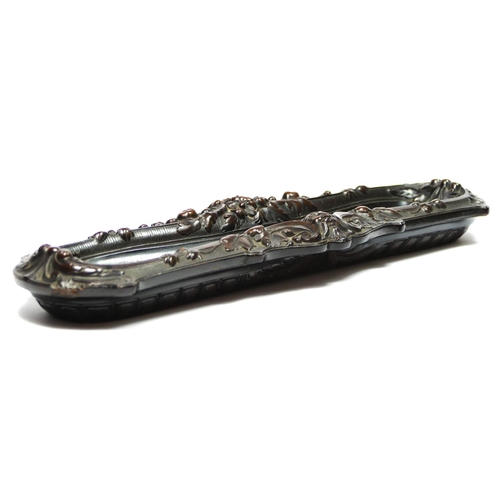 135 - A 19th century French carved lignum vitae pen tray, with mask and floral decoration, 31 x 10cm.