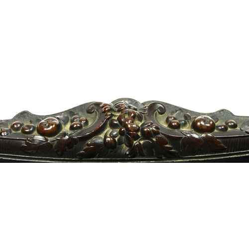 135 - A 19th century French carved lignum vitae pen tray, with mask and floral decoration, 31 x 10cm.