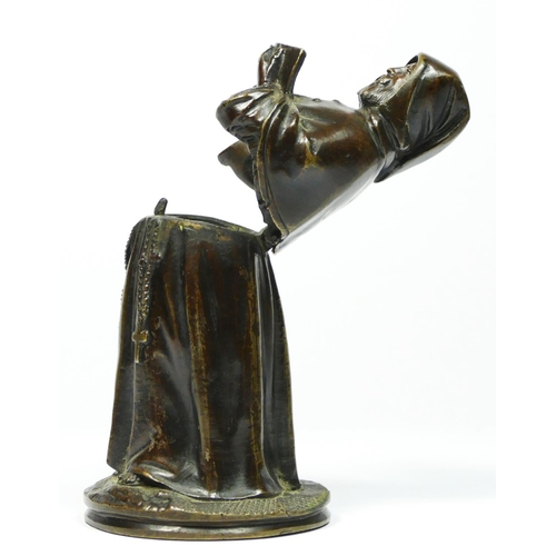 137 - A bronze novelty match holder, in the form of a monk, hinged at the waist, striker on the ground, 13... 