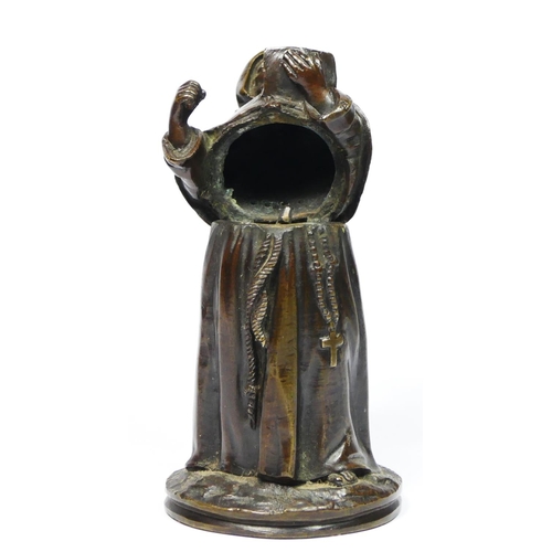 137 - A bronze novelty match holder, in the form of a monk, hinged at the waist, striker on the ground, 13... 