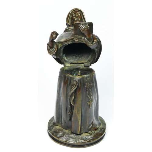 137 - A bronze novelty match holder, in the form of a monk, hinged at the waist, striker on the ground, 13... 