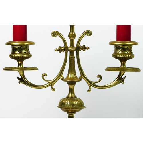 164 - A pair of gilt brass twin sconce candlesticks, supported on four, these give way to a square stepped... 